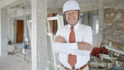 Sticker - Senior grey-haired man architect smiling confident standing with arms crossed gesture at construction site