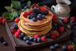 pancakes with berries on a wooden table
