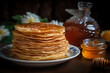 pancakes with honey on a wooden table, close-up