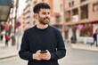 © Krakenimages.com - Young arab man smiling confident using smartphone at street