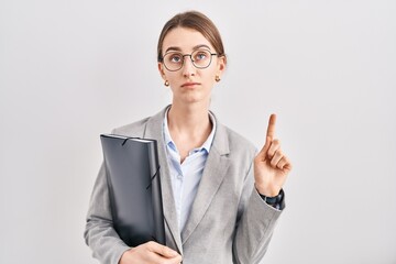 Sticker - Young caucasian woman wearing business clothes and glasses pointing up looking sad and upset, indicating direction with fingers, unhappy and depressed.