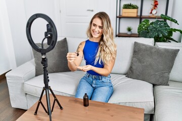 Sticker - Young woman recording skin care tutorial by smartphone at home