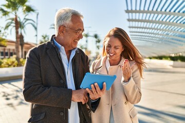 Poster - Middle age man and woman couple smiling confident using touchpad at park