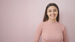 Young beautiful hispanic woman smiling confident standing over isolated pink background