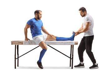Wall Mural - Physical therapist checking the foot of a football player