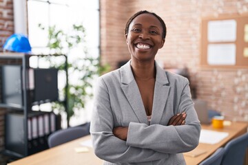 Wall Mural - African american woman at the office happy face smiling with crossed arms looking at the camera. positive person.