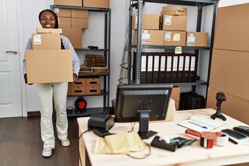 Canvas Print - African american woman ecommerce business worker holding packages at office