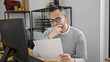 © Krakenimages.com - Hispanic man business worker reading document at office