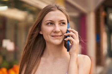 Sticker - Young caucasian woman smiling confident talking on the smartphone at street