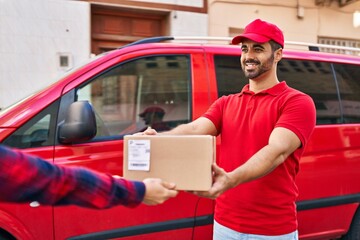 Sticker - Young hispanic man courier giving package at street