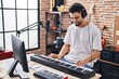 © Krakenimages.com - Young arab man musician playing piano keyboard at music studio