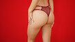 © Krakenimages.com - Young caucasian woman wearing lingerie touching ass over isolated red background