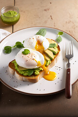 A piece of toast topped with avocado and poached eggs, generative AI