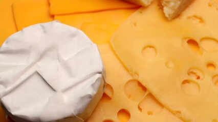 Wall Mural - Set of different cheeses, rotation in circle. Camembert, Cheddar, cheese with holes, maasdam, Parmesan, Turning. selective focus.