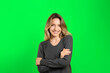 canvas print picture - Chroma key compositing. Pretty young woman smiling against green screen