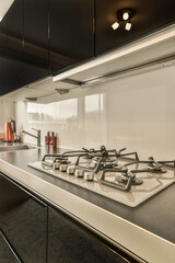 a modern kitchen with black counters and white backsplases on the stovetop in this image is taken from above