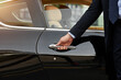© Cecilie Arcurs/peopleimages.com - Businessman, hands and chauffeur by car door for travel accommodation, designated driver or commute. Hand of male person on vehicle handle in professional transport service, business class or pick up