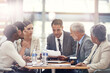 © Tabitha Rose/peopleimages.com - Planning, talking and business people with a report in a meeting for financial strategy or investment. Teamwork, diversity and employees in accounting with paper for results on investing or economy
