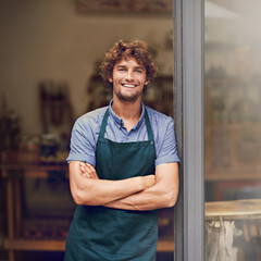 Retail, arms crossed and portrait of man at restaurant for small business, coffee shop and waiter. Entrepreneur, happy and smile with male barista at front door of cafe for diner and food industry