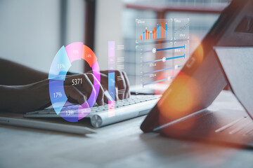 Businessman trader or analyst is sitting at workplace and working on laptop to develop data management in high tech company.
