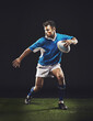 © Duncan M/peopleimages.com - Rugby, black background and man athlete running in dark studio while training, wellness and fitness sports. Exercise, workout and professional career of sport male person or player on grass