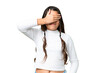 Young girl over isolated chroma key background covering eyes by hands. Do not want to see something