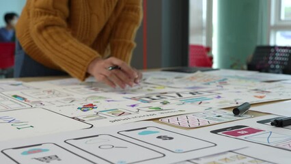 Close up ux developer and ui designer brainstorming interface wireframe design.Creative digital development agency