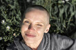 © Konstiantyn Zap - Portrait of a smiling bald woman on a background of grass.