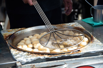 Loukoumades (Greek/Cypriot donuts with honey) cooked at village fair in Cyprus