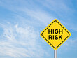 © bankrx - Yellow transportation sign with word high risk on blue color sky background