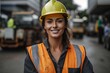 Portrait of female worker in hardhat smiling at camera in warehouse