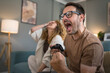 © Miljan Živković - couple man and woman husband wife play console video games at home