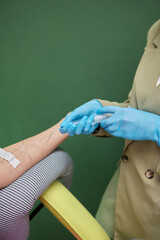 Wall Mural - Doctor drawing blood sample from arm for blood test, close-up. Phlebotomist technician drawing blood for testing Coronavirus COVID-19 disease infestation. Concept of healthcare and medicine.