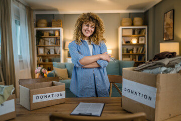 Wall Mural - One young adult woman prepare wardrobe clothes for charity donation