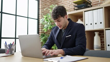 Poster - Young hispanic man business worker opening laptop at office