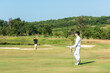 © freebird7977 - Golfer sport course golf ball fairway.  Group People lifestyle man and friend playing game golf tee off on the green grass. Asia men player game shot in summer