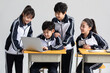 © Blue Jean Images - Students learning with laptop in classroom
