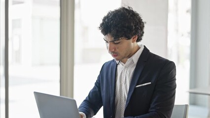 Sticker - Young latin man business worker using laptop smiling at office