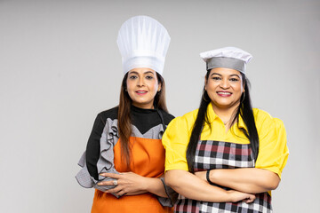 Indian female chef giving happy expression on white background.