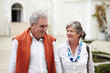 © Thomas Talkner/peopleimages.com - Happy, talking and a senior couple in the city for a retirement holiday, travel and happiness. Smile, love and an elderly man and woman walking in an old town or hotel during a vacation together
