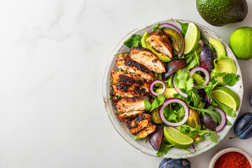 Wall Mural - Grilled chicken fillet salad with arugula, avocado, plums, paprika, onion and lime in a plate on white background