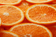Slices Of Ripe Orange Backlit As A Textural Background. Full Screen, Close-up, Macro