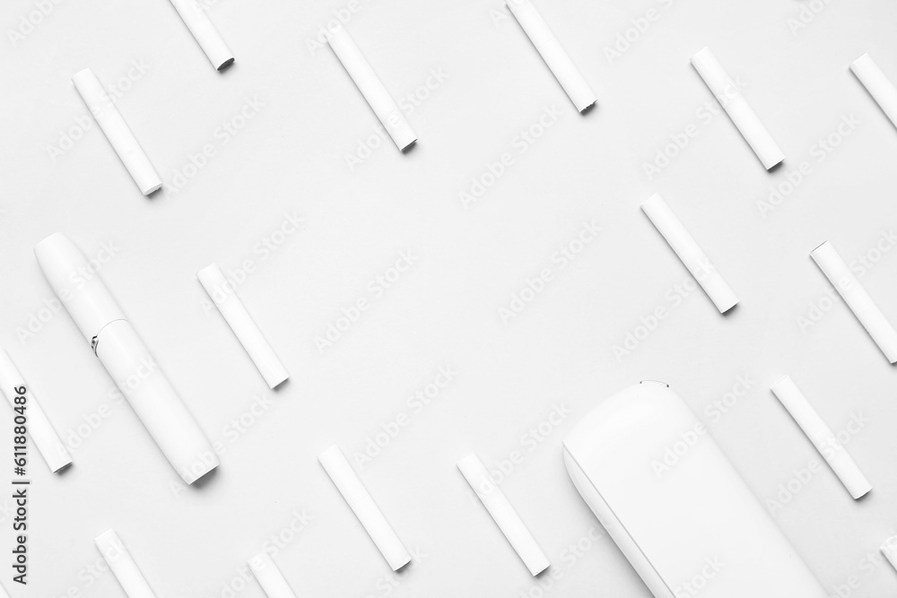 Modern electronic cigar and many sticks on grey background