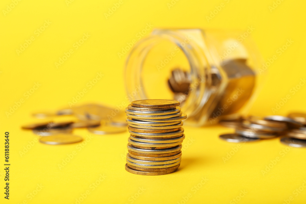 Stack of coins on yellow background
