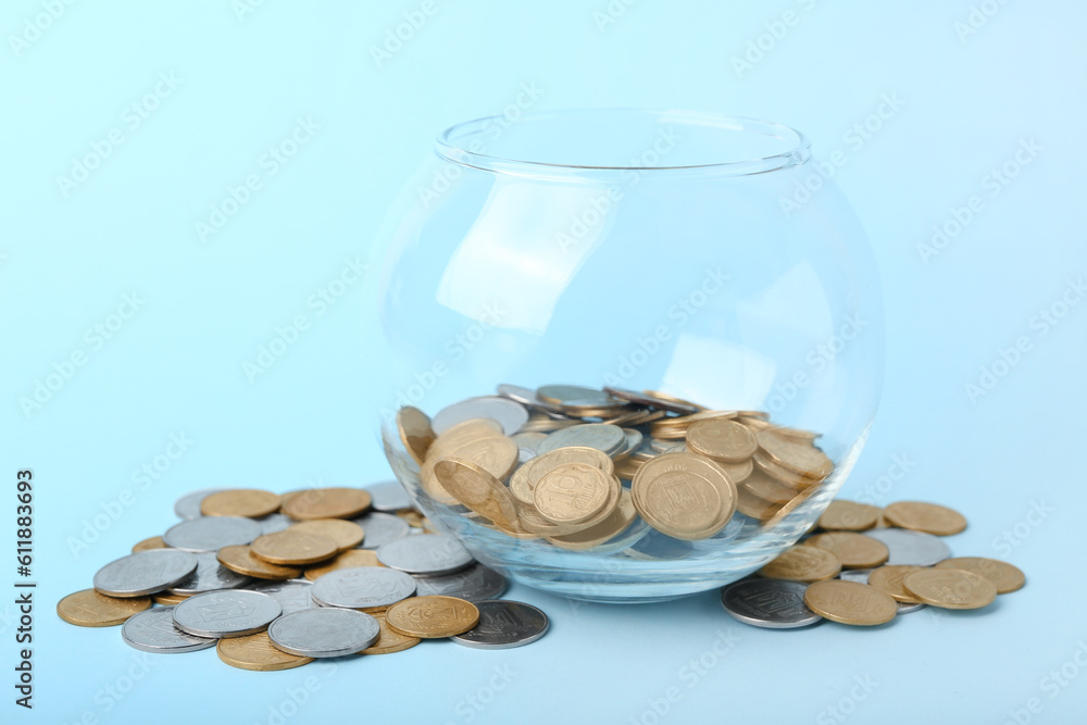 Jar with coins on blue background. Savings concept