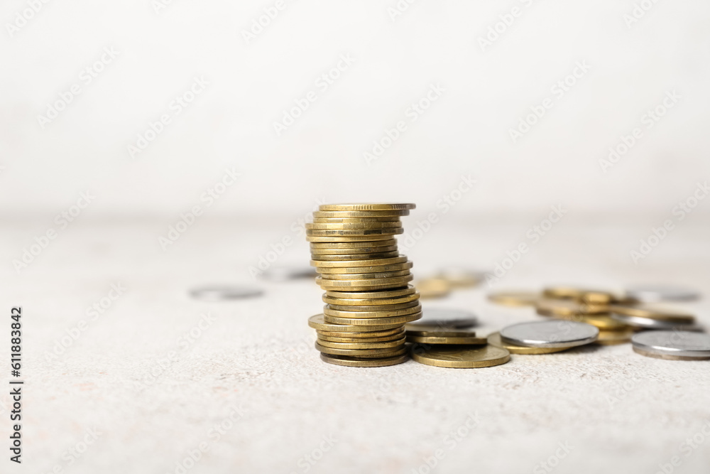 Stack of coins on beige grunge table