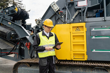 Aufkleber - Engineer with digital tablet next to road construction machine.