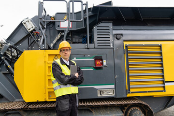 Aufkleber - Engineer with digital tablet next to road construction machine.