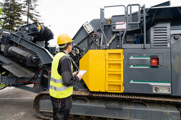 Aufkleber - Engineer with digital tablet next to road construction machine.