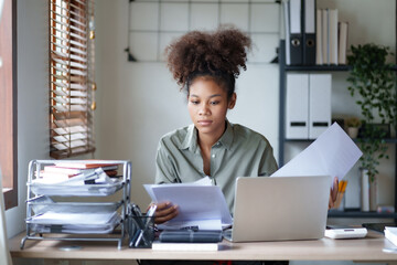 Young afro african american millennial employee trainee working on office desk.